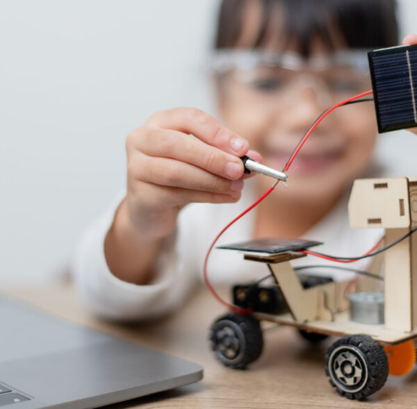 Asia students learn at home in coding robot cars and electronic board cables in STEM, STEAM, mathematics engineering science technology computer code in robotics for kids concept.