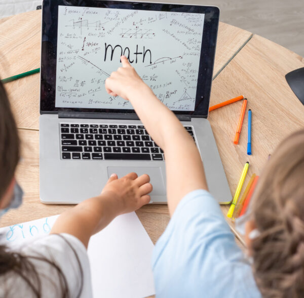 Distance learning online education. A school girls study at home and do school homework. A home distance learning