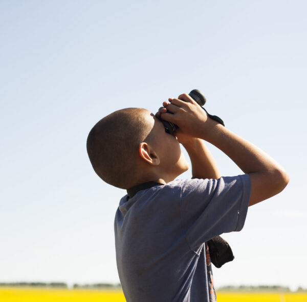 Boy using binoculars
